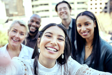 Obraz premium I find the harder we work, the more we have. Shot of a group of business colleagues taking selfies outside.
