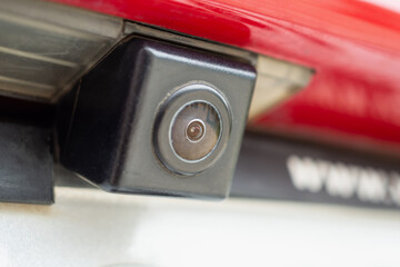 Red car rear view camera close up for parking assistance