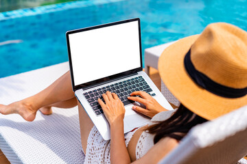 Young woman freelancer traveler working online using laptop while traveling on summer vacation,...