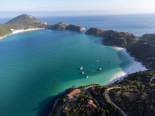 Fototapeta premium the most beautiful paradise bay with turquoise water beaches in the world. Caribbean and Thai style. Aerial drone cinematic view. Arraial do Cabo, Rio de Janeiro, Brazil - Praia do Pontal do Atalaia a