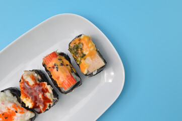 Japanese seafood sushi set on a white plate. maki and rolls with tuna , salmon, shrimp, crab and avocado.