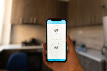 Home heating temperature control with smart home, close-up on the phone. Smart home concept and smart home control application
