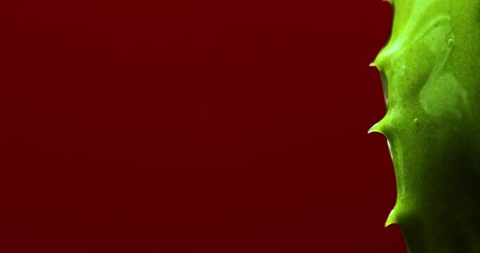 Alora vera leaf with juice, gel runs of on brown background, natural medical plant for organic cosmetics, alternative medicine