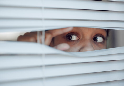 Paranoid delusions they haunt you. Shot of a young female experiencing paranoia at home.