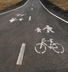 Road sign for cycle and pedestrians on the asphalt. White painted sign for for bicycles and pedestrians lane.