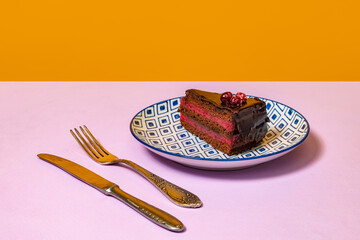 Dessert. Food pop art photography. Plate with cake on lilac color tablecloth over orange...