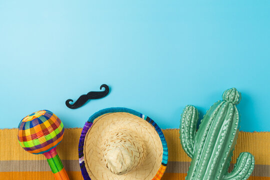 Cinco de Mayo holiday background with Mexican cactus, maracas and party sombrero hat. Top view, flat lay