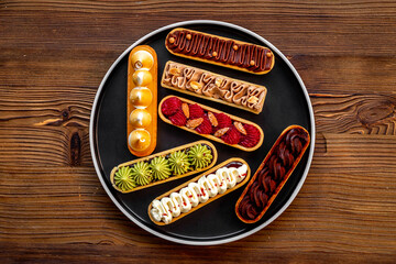 Set of delicious dessert eclairs with colorful topping