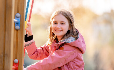 Beautiful little girl playing at the playground