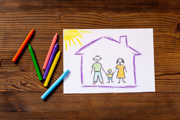 Childrens pencil drawing of family in house. Mortgage concept