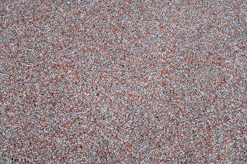 Photography of a grainy texture on the floor of a children's playground. Rubber flooring