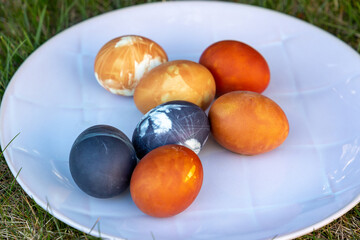 Colorful easter eggs on a plate, a close up, natural dye