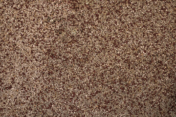 Photography of a grainy texture on the floor of a children's playground. Rubber flooring