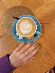 female hand and cup of coffee in creative coffee shop, st. petersburg. Russian coffee shops, Russian architecture. aesthetics of relaxation, coffee and petersburg