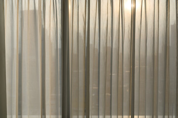 Sheer curtains with cityscape onbackground. transparent curtain in cozy room home, interior design concept.
