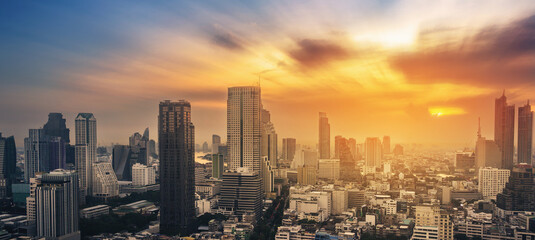 Fototapeta premium Cityscape of modern buildings and urban architecture. Aerial view of Bangkok city at twilight sunset in Thailand.