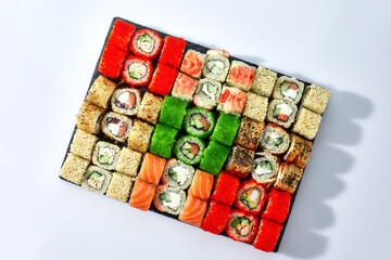 Japanese food restaurant, sushi maki gunkan roll plate or platter set. California Sushi rolls with salmon. Sushi isolated at white background. Top view, flat lay.