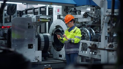 Engineer holding transparent tablet computer on industrial manufacture factory. - Powered by Adobe