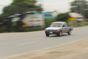 Fototapeta na wymiar pick-up Speeding in road, panning camera, Thailand asia