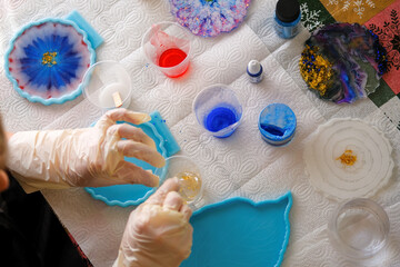 Woman making epoxy resin arts and crafts. - obrazy, fototapety, plakaty