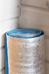 Thermal insulation material roll made of polyethylene foam covered with aluminium foil. Covering...