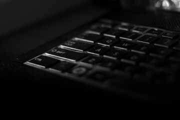 low light of laptop keyboard with dark background. black and white photography. copy space for computer accessories, computer spare parts and laptop hardware. - Powered by Adobe