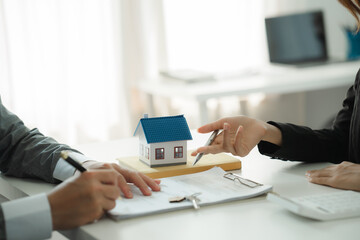 Real estate broker agent presenting and consult to customer to decision making sign insurance form...