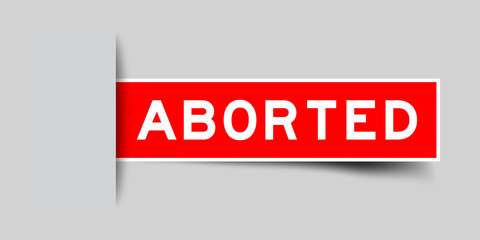 Inserted red color label sticker with word aborted on gray background