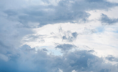 white cirrus, feathery clouds against spring bright blue cloudy sky on sunny day in England
