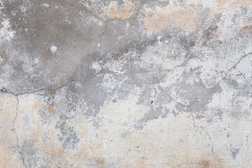 Old flaky wall with destroyed plaster. Renovation of old house. Industrial style design wall background. Grunge cracked concrete wall with old paint. Shabby peeling old background