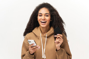 E-banking and ecommerce concept. Smiling multiracial female with Afro hairstyle holding modern...