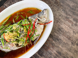 The snapper is cooked by steaming with soy sauce. Chinese Thai food Style top view.