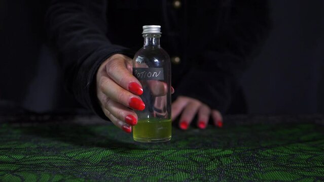 Halloween witch with bottle of potion 