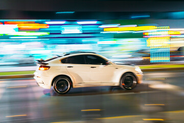 White Premium SUV Car Fast Moving In City Street. Motion Blur Background.