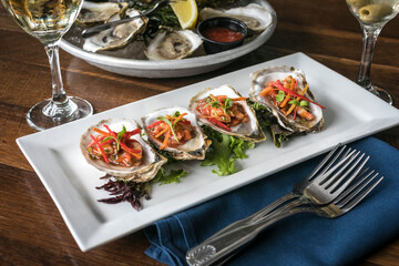 Four Oysters on a White Plate
