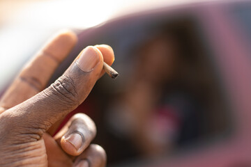 black person holding a joint