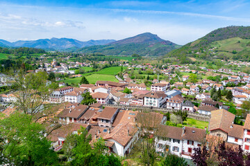 Fototapeta na wymiar Cityscape of Saint Jean Pied de Port village, France. Views of the entire town with a panoramic view of a colorful landscape. Horizontal photography.