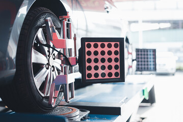 Closed up of an auto wheel : wheel alignment. Balancing tire wheel machine. Tyre assembling. Tire balance - Car service