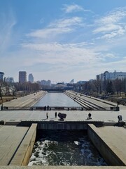 Bridge and fast flowing river in the city during the day