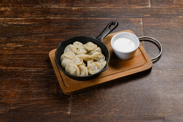 dumplings in a pan with sour cream