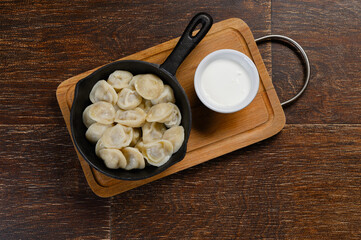dumplings in a pan with sour cream