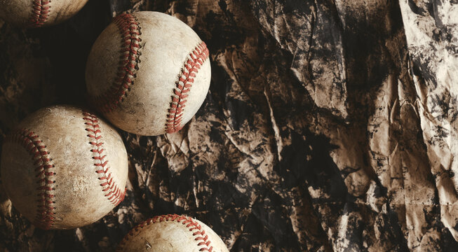 Old grunge baseball background with flat lay of sports balls.