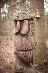 A statue of an owl carved from a tree trunk © Joanna