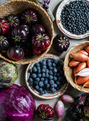 purple and red, violet vegetables on the purple background, top view. purple  artichoke, tomatoes,...