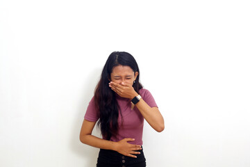 Beautiful asian girl standing holding her stomach and feeling nauseous and going to vomit