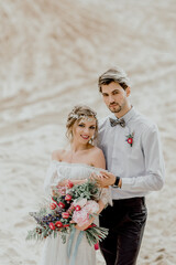 The bride and groom in the desert. Wedding in the sands of Dubai.