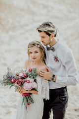 The bride and groom in the desert. Wedding in the sands of Dubai.