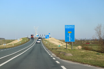 Fototapeta premium Blue direction and information sign for the directions on road N219 in Nieuwerkerk aan den IJssel