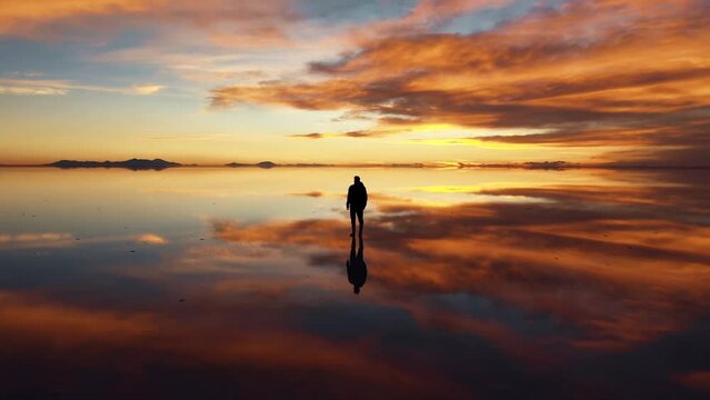 A man standing at a cloudy sunset point reflection. beautiful cloudscape
