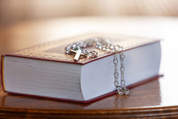 Holy Bible and Rosary with cross